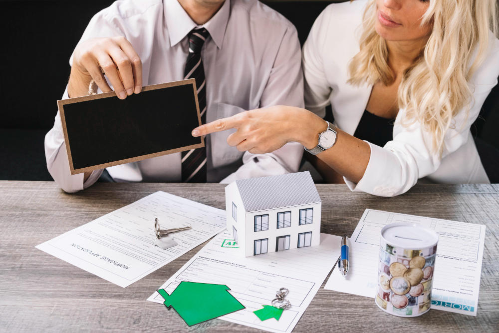 Woman pointing at chalkboard in estate agency
