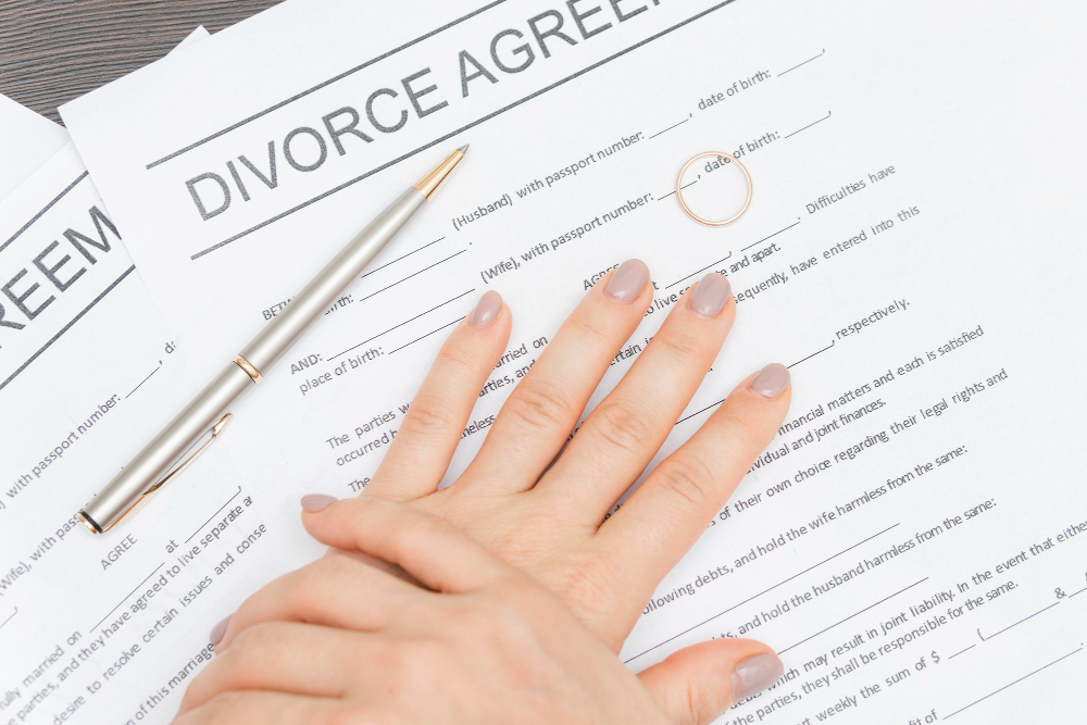 Close-up hands with divorce documents
