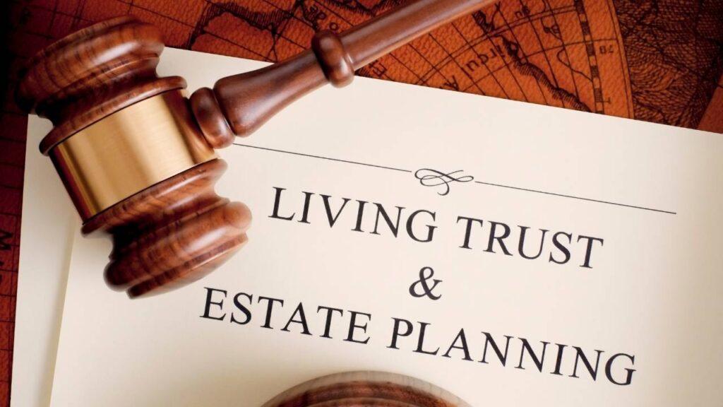 Living trust and estate planning paper with judges mallet Living trust and estate planning paperwork sitting on an orange map with a judges mallet on top of it