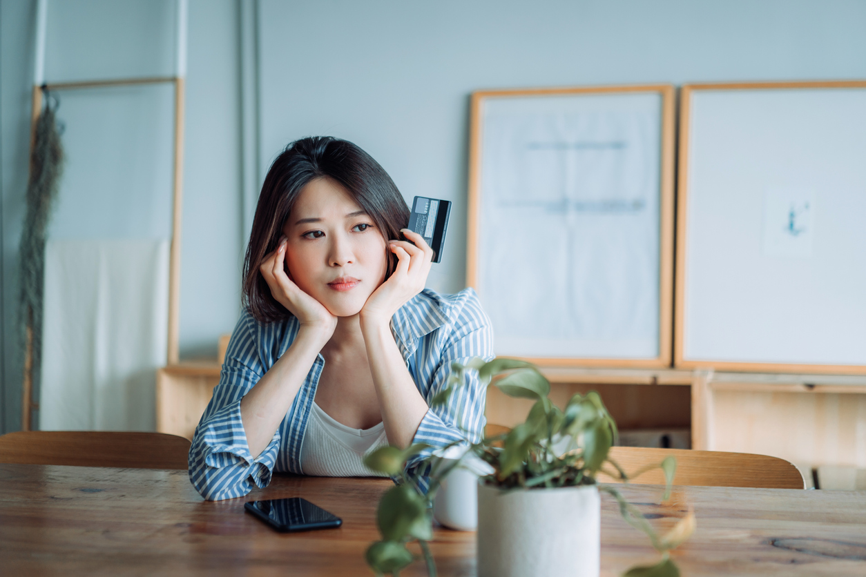 worried-woman-holding-credit-card