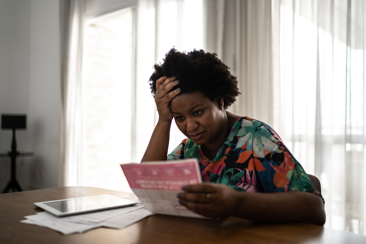 worried-woman-looking-at-bill