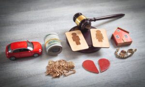 A judge gavel and a heart on a wooden table.