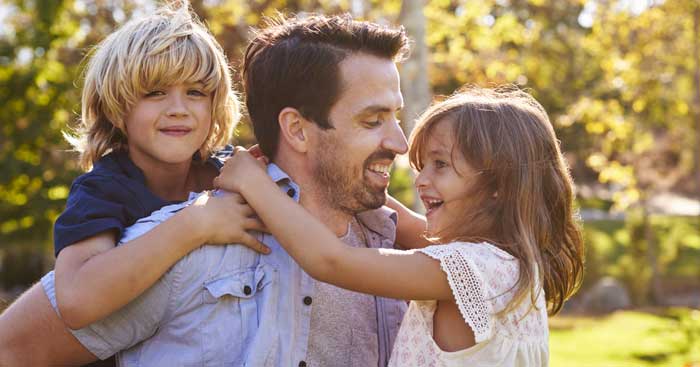 family embracing in sun