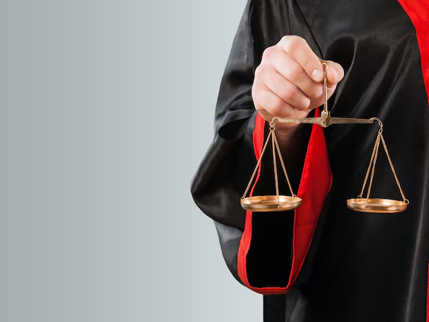 A person in a black and red robe holds a small balance scale in one hand against a plain background, symbolizing the careful weighing of life's important decisions,