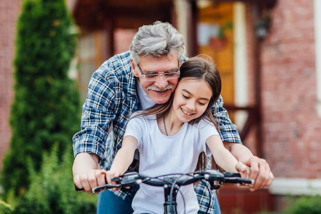 In a serene garden setting, an older man gently guides a young girl as she learns to ride her bicycle, his wisdom extending beyond simple lessons to life's larger questions—like what estate planning documents do I need for ensuring future peace of mind.