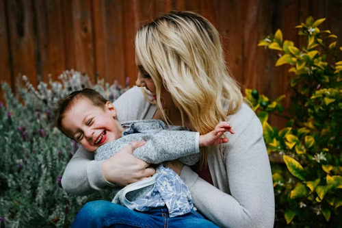 mother playing with her child in article what does custodial parent mean