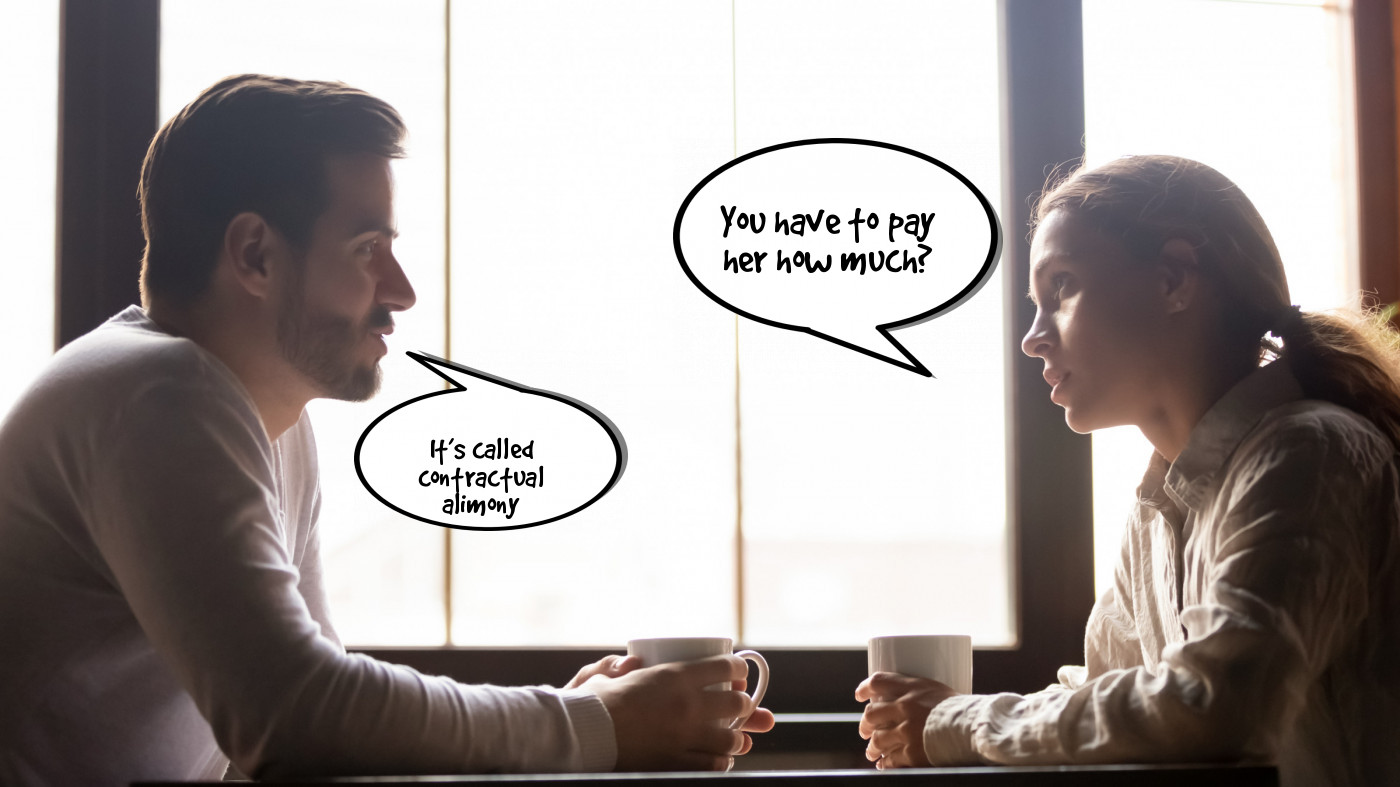 A man and woman are sitting at a table with a cup of coffee.