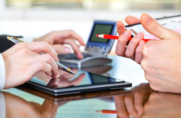 Two business people holding a tablet and a pen, discussing debt collections.