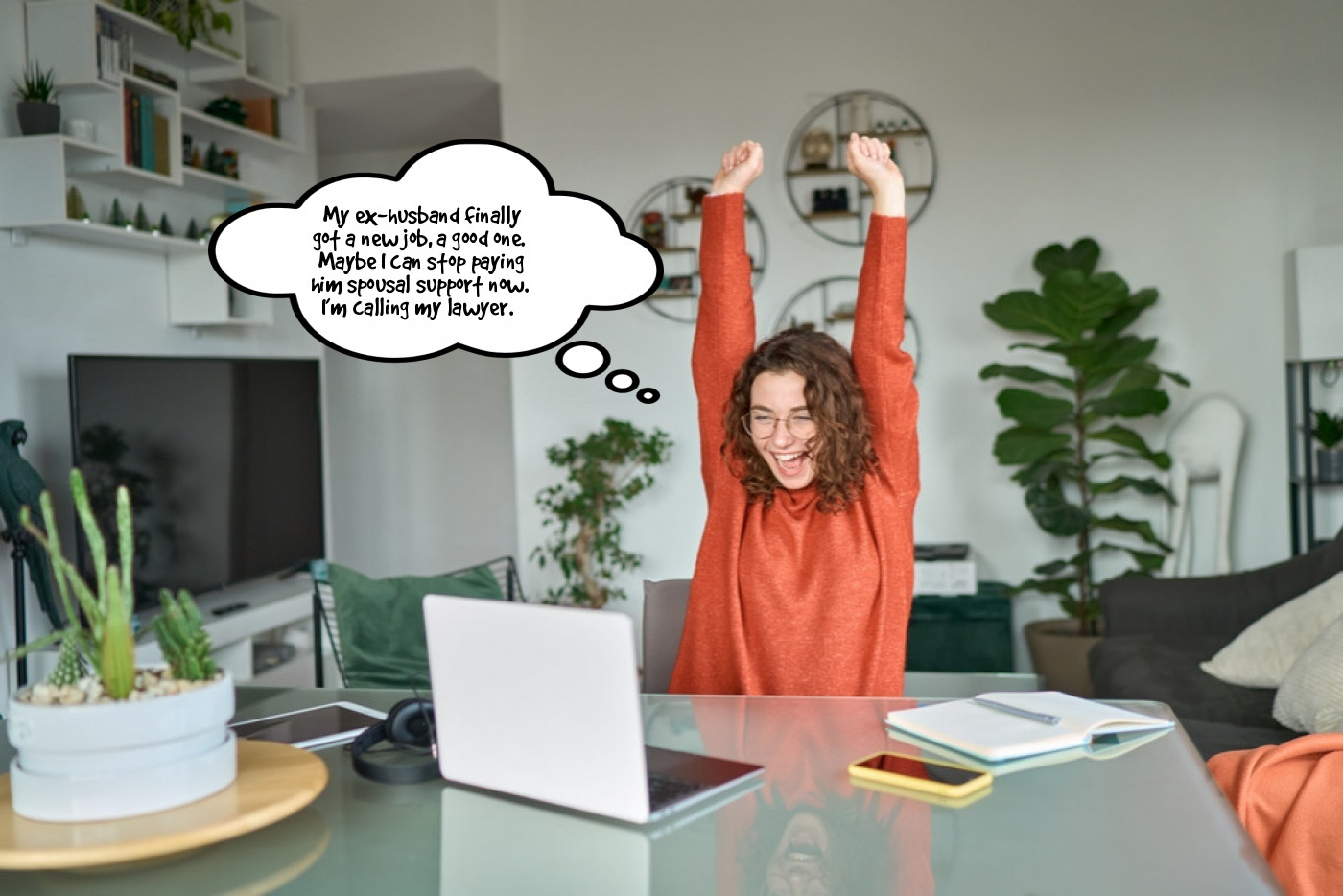 A woman is sitting at a desk with a laptop and a speech bubble.