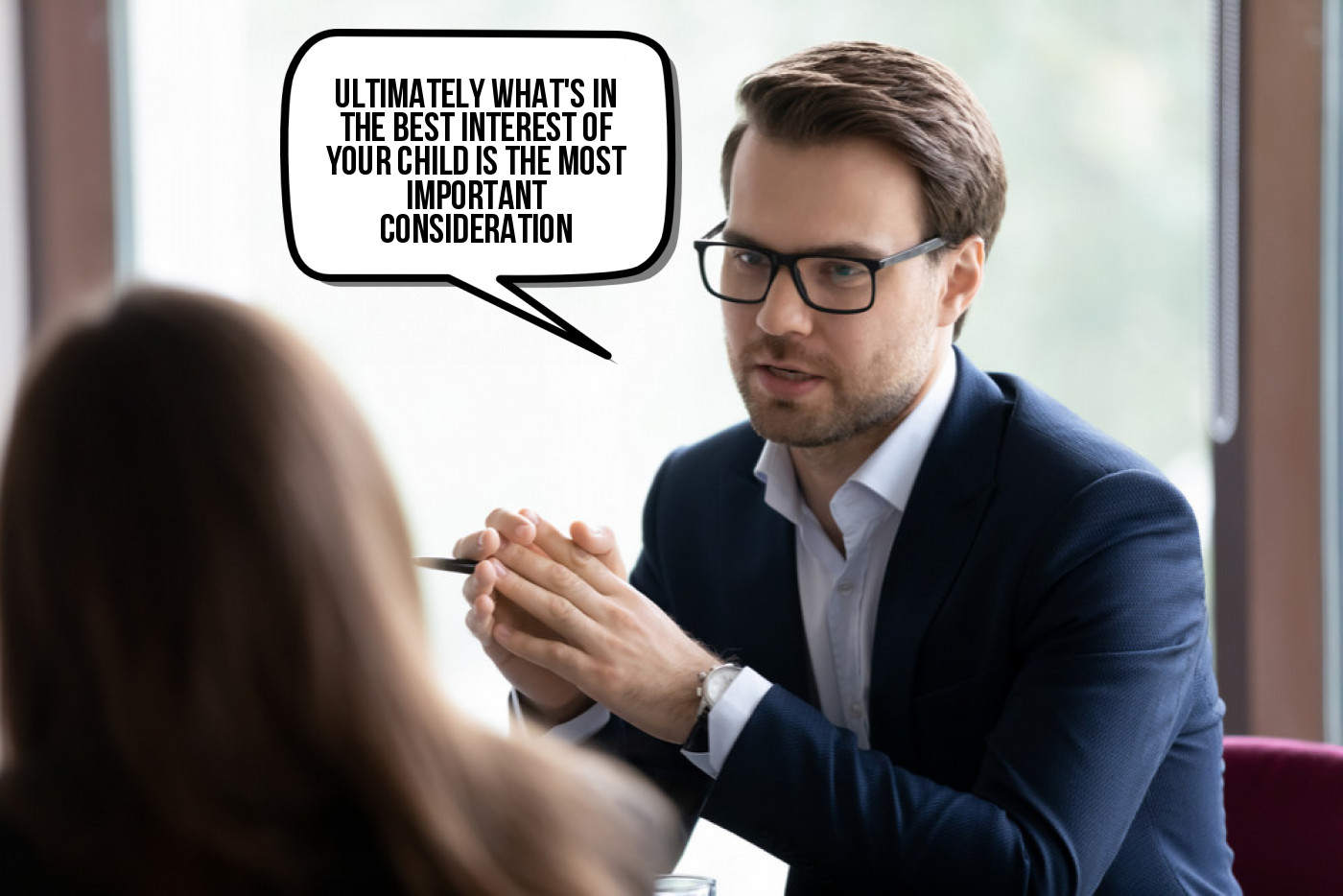 A man is talking to a woman in a business meeting.