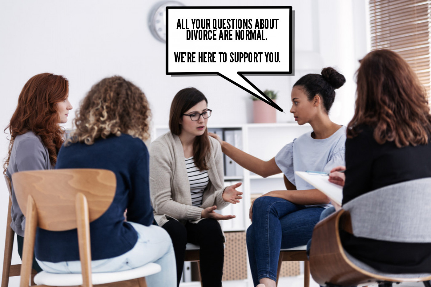 A group of women sitting in a room talking to each other.