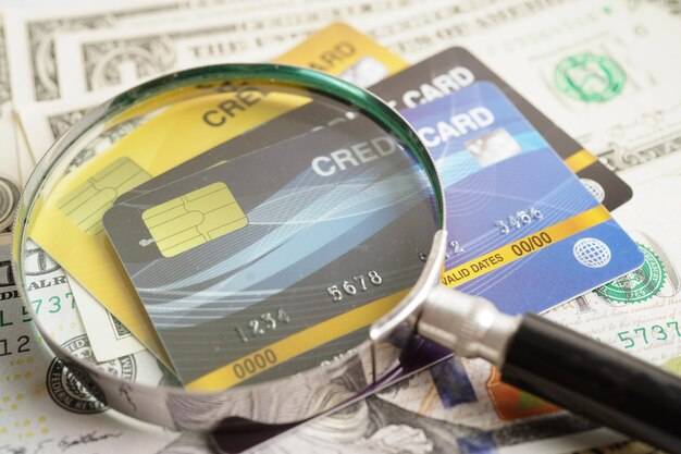 A Credit Card Debt Lawyer scrutinizing credit cards under a magnifying glass.