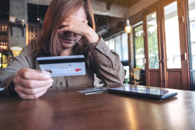 A woman holding a credit card.