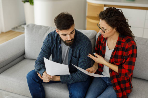 Young couple going through their paperwork together at home, can a spouse change a trust after death