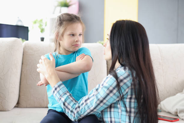 Sad offended daughter sitting on couch, turning back to mother after quarrel at home. Family misunderstanding and childhood problems. Learn can parents agree to no child support in texas