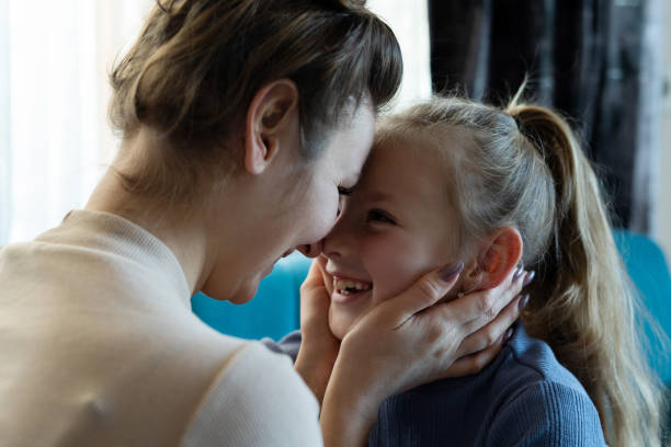 Mother and daughter face to face at home