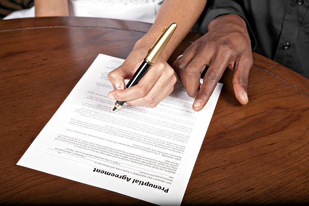 man signing the divorce agreement