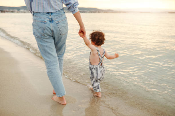 Shot of a young woman spending time at the beach with her adorable boy - How Many Overnights is 50 50 Custody in Texas?