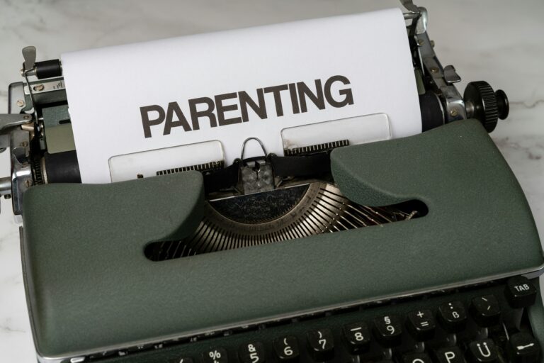 A typewriter with a sheet of paper displaying the word "PARENTING" in bold capital letters, prompting questions like, "Do minors have to pay child support in Texas?.