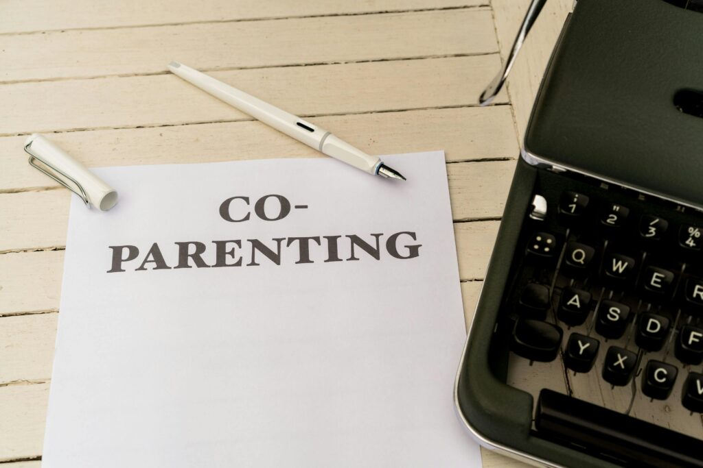 A paper stating co parenting next to calculator