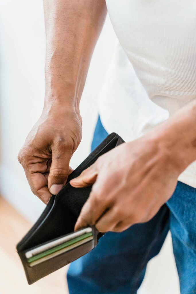 Man opening empty wallet