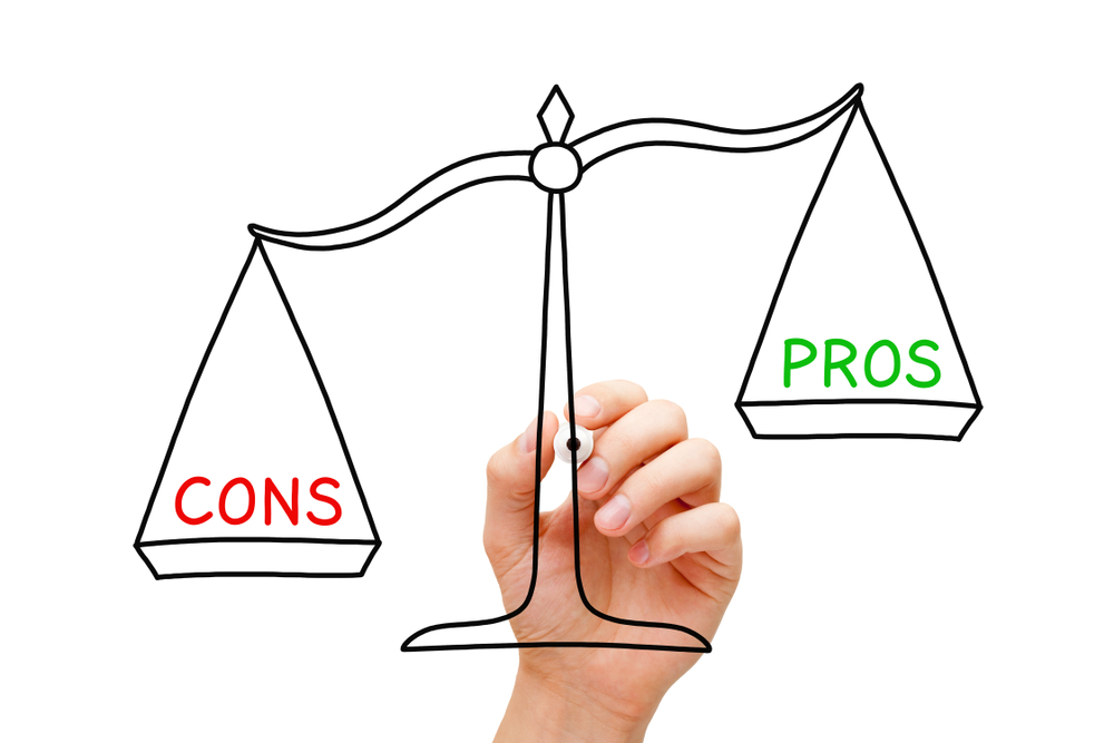 A hand drawing out the justice scale in black marker with the word pro on the right side and it is higher than the word con on the left side