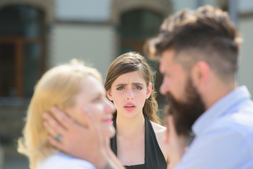 Full of jealousy. Romantic couple of man and woman dating. Jealous girl look at couple in love on street. Bearded man cheating his woman with another girlfriend. Unhappy woman feeling jealous.