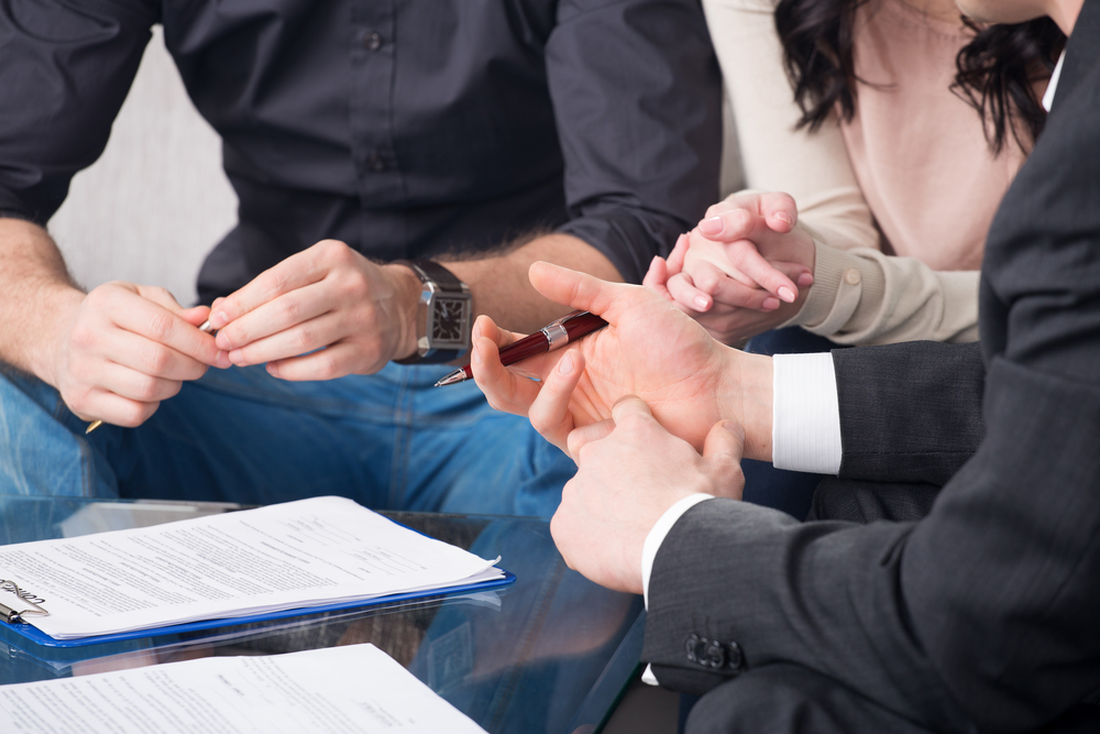 "does poa end at death" article showing hands of people, sitting on the desk, signing the estate document