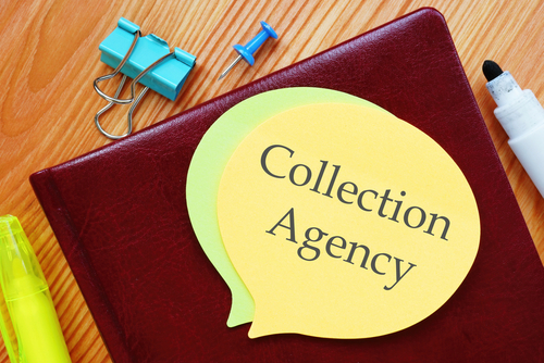Desk items include a notebook with speech bubble-shaped papers reading "Can a collection agency sue you after 7 years?" alongside a yellow highlighter, binder clips, push pins, and a white marker on a wooden surface.