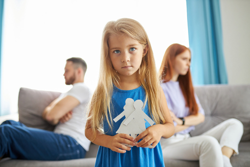 sweet little caucasian child girl holding family picture drawing feeling upset about parents divorce, innocent sensitive little kid suffer from trauma offended by fights conflicts shared custody