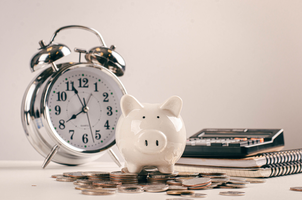 Debt collection and tax season concept with bank coin deadline, calculator on the table, background, payment time concept