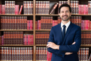 Male Attorney With Arms Crossed. Lawyer In Office