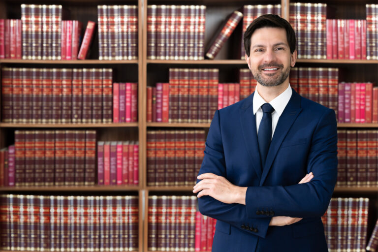 Male Attorney With Arms Crossed. Lawyer In Office