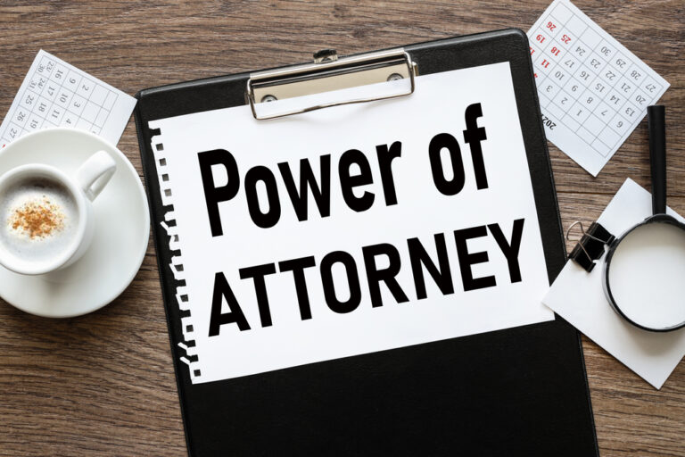 Power of Attorney. text on wood table, on white paper