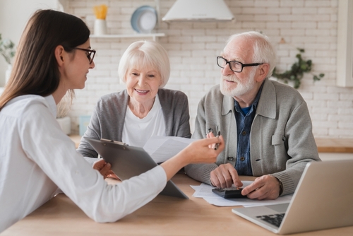 Successful deal. Lawyer financial adviser helping consulting showing contract mortgage loan credit business startup, signing documents by elderly senior old grandparents couple at home