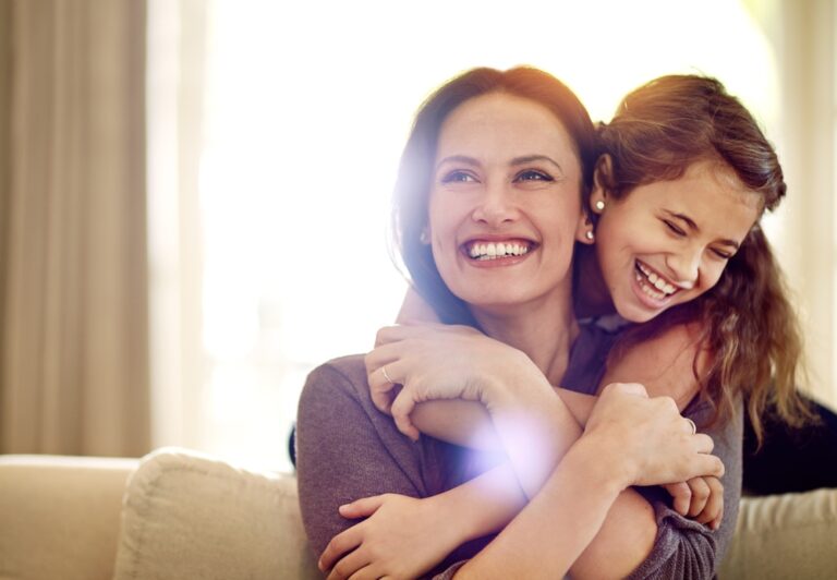 mother hugging her daughter happily