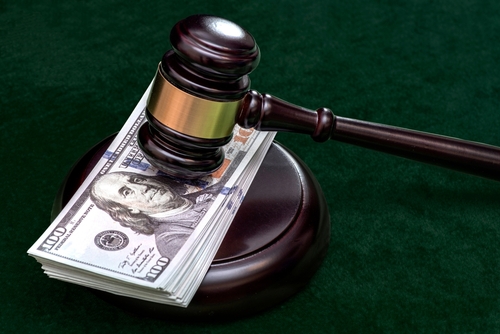 Judge and money concept. Judge's gavel on the table. Judge's hammer for verdict, justice judgment at courts of law. American One Hundred Dollar Bill, corruption, cost, finances, expenses, salary.