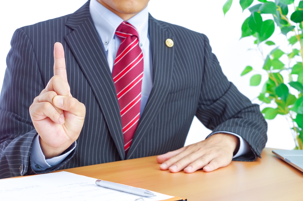 a male lawyer advising the client on debt defense