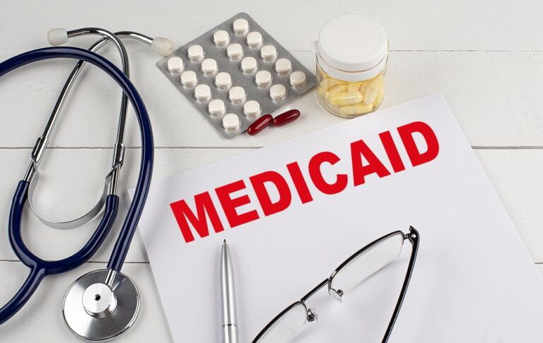 MEDICAID text on a keyboard with stethoscope , medical concept