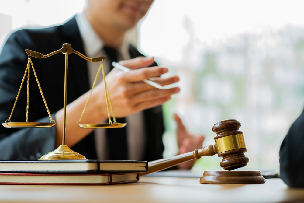 Legal services concepts at the Computer Labor Law Advising Office. lawyer working at the desk Hammer and scales on lawyer's table for justice