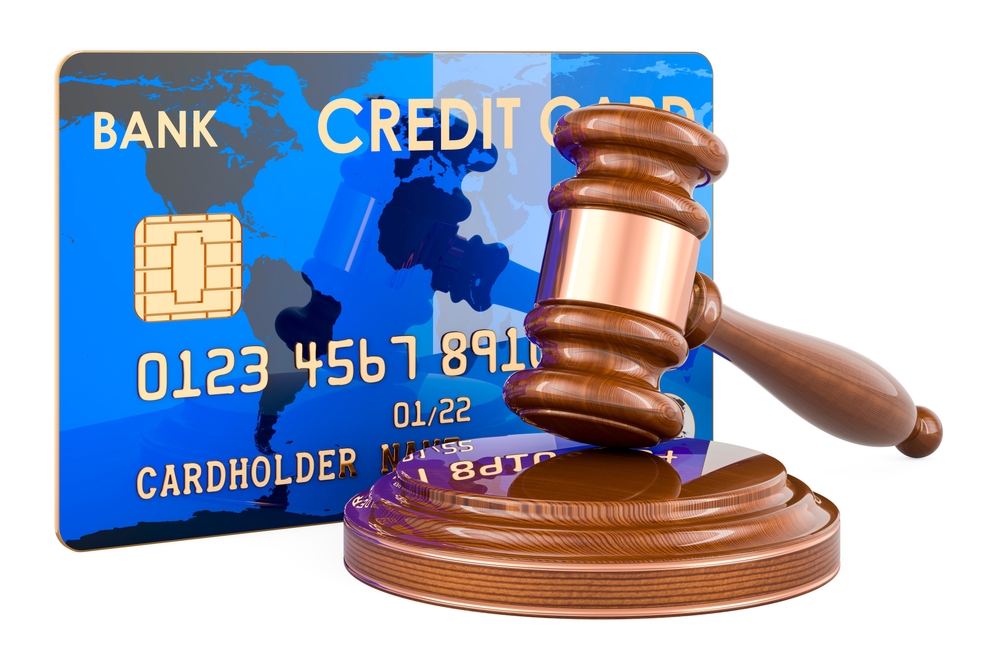 Credit card with wooden gavel, 3D rendering isolated on white background