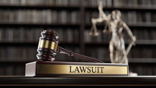 Lawsuit: Judge's Gavel as a symbol of legal system, Themis is the goddess of justice and wooden stand with text word on the background of books. 3D Illustration for what happens when a credit card company sues you