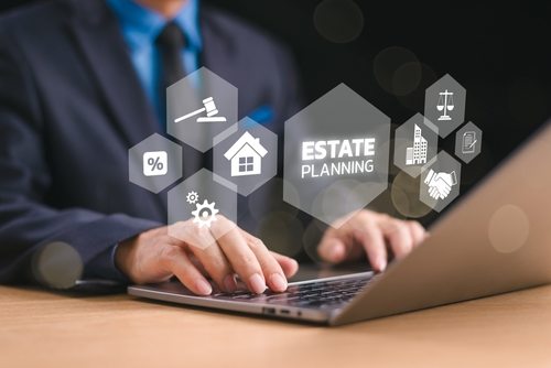 A person in a suit types on a laptop with estate planning icons, including a house, gavel, and handshake, in the foreground—setting the stage for your free consultation.