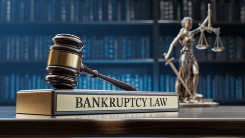 A gavel rests on a "Bankruptcy Law" book with Lady Justice statue in the background, set in a library, quietly posing the question: can I exclude a credit card from Chapter 7?.