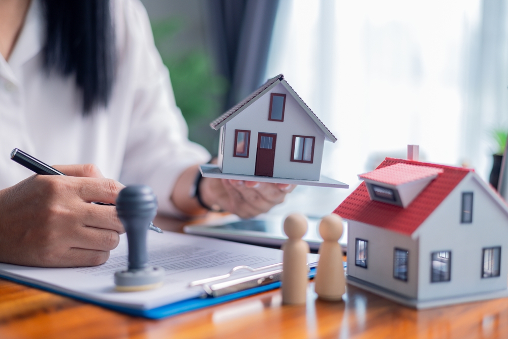 Businessperson decided to buy new home, securing loan to finance property and obtaining insurance for house, with the real estate agent facilitating sale and handing over home key. insurance, estate.