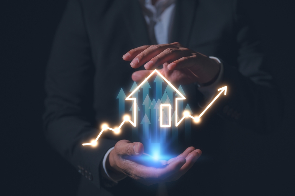 Real Estate investment Businessman holding building or house chart graph of real estate icons. Engineering and construction. Investment and business development