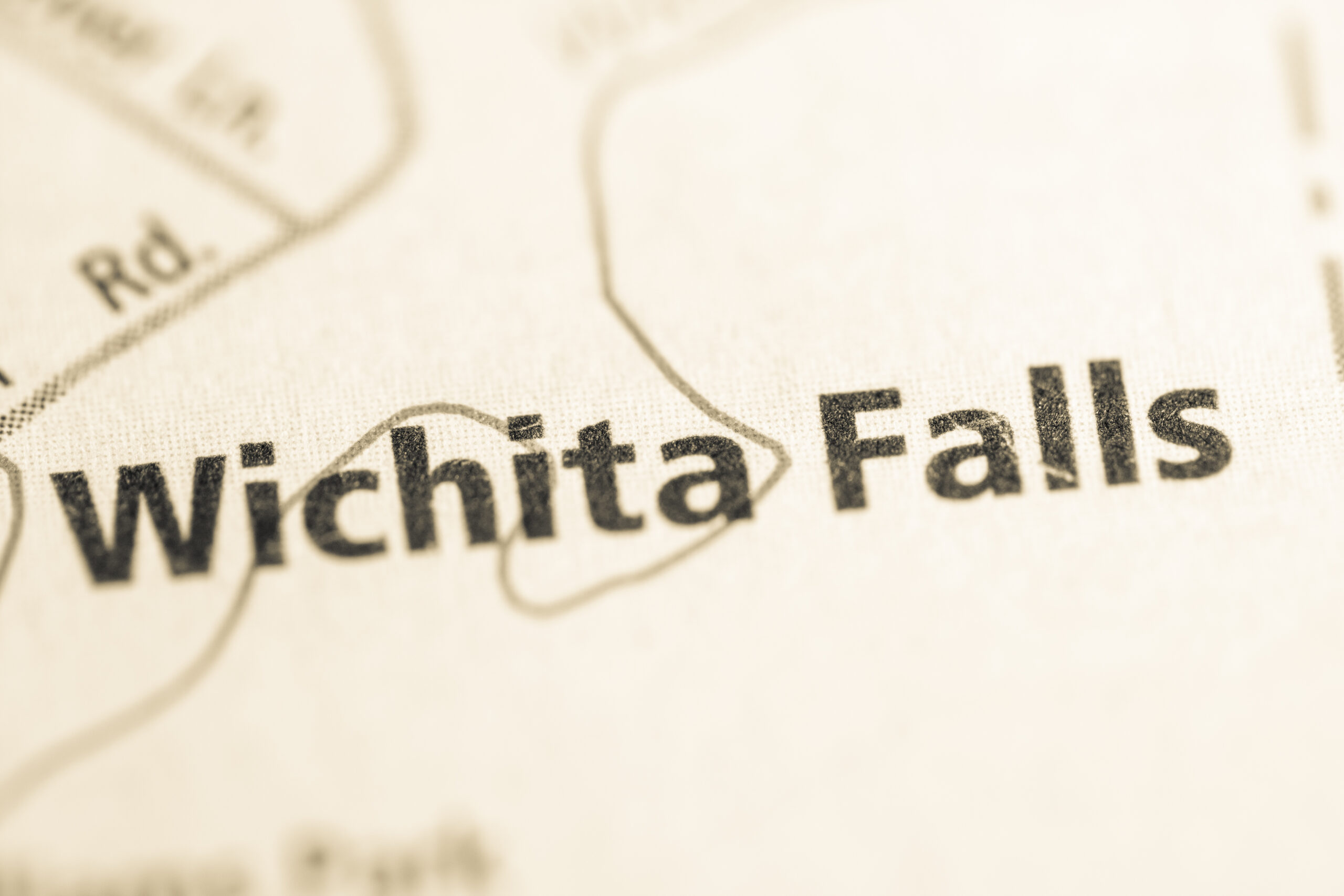 Close-up of a map highlighting the city of Wichita Falls in focused text with blurred surroundings, relevant for Wichita Falls.