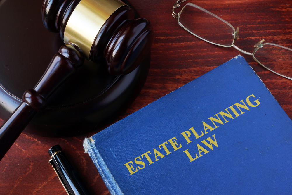 Book with title estate planning law and a gavel. Can Medicaid Take Your Home in Texas?