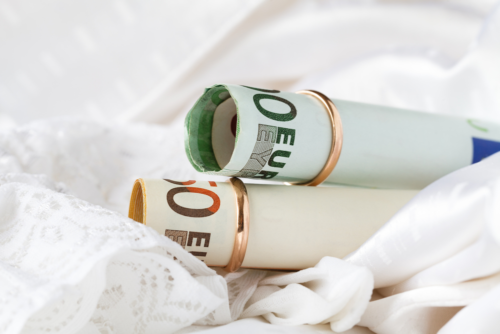 Female divorce lawyer working with mature couple at table in office, explaining dividing rsus and stock options in texas divorce