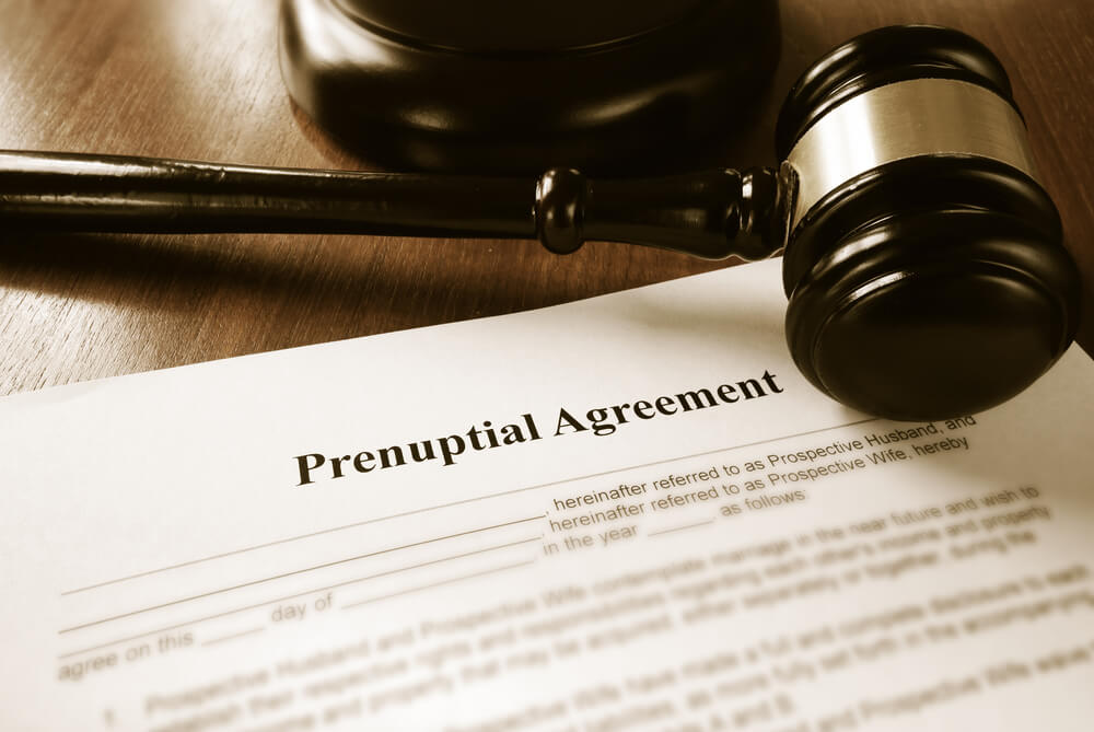 A paper that says Prenuptial agreement with a judges gavel rest on the paper